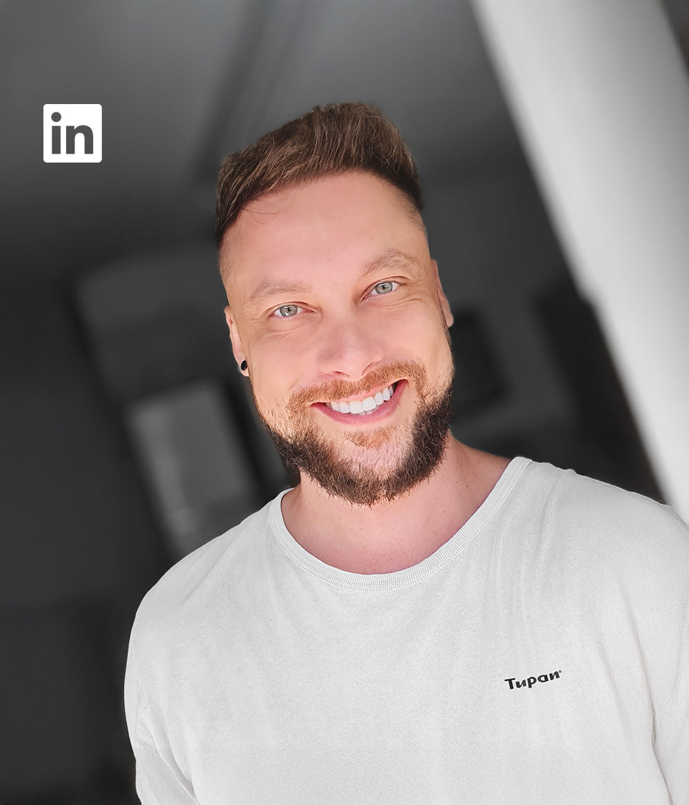 Portrait of Mario Souto, co-founder of Tupan, wearing a white T-shirt with the Tupan logo — representing the bold spirit behind açaí coffee innovation.