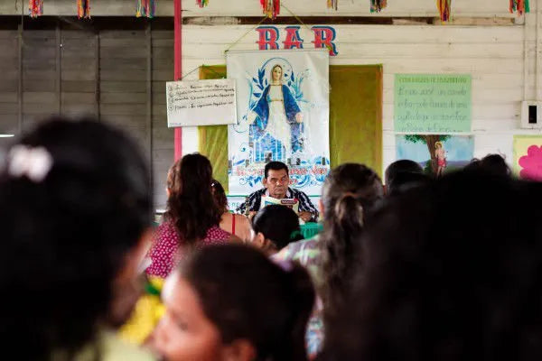 Community gathering in an Amazonian riverside village connected to the Amazonbai cooperative, reflecting local culture, social organization, and the collective spirit behind fair trade açaí sourcing for Tupan Açaí Coffee.